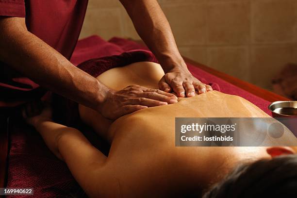 caucasian enjoying an ayuverdic massage - massage therapy stock pictures, royalty-free photos & images