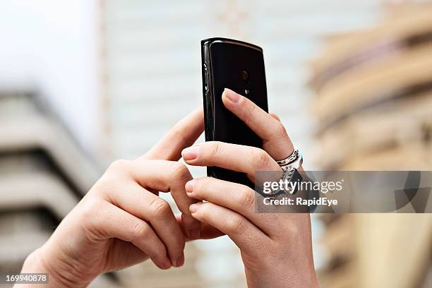 struggling for a signal, female hands hold mobile phone aloft - radio wave stock pictures, royalty-free photos & images