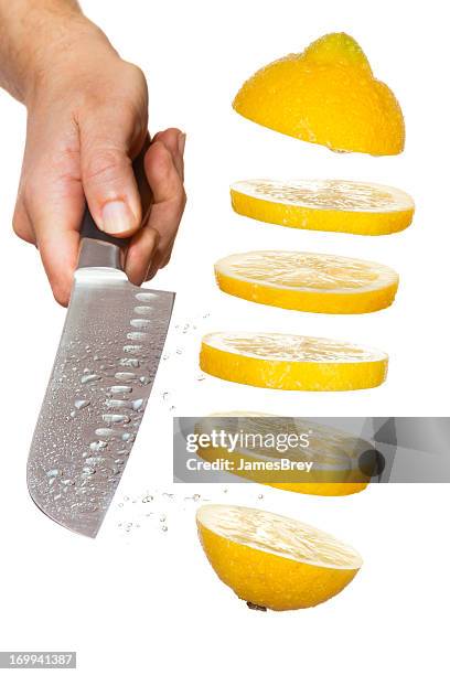 chef's knife slicing lemon in mid-air - cut lemon stockfoto's en -beelden