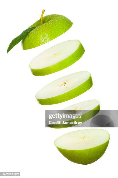 sliced green apple slices tossed in air - apple slice stock pictures, royalty-free photos & images