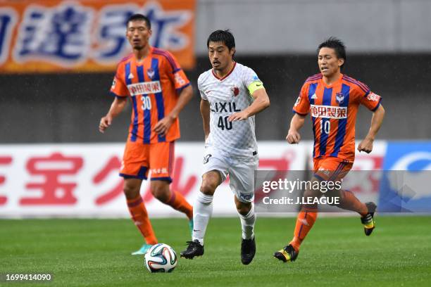 Mitsuo Ogasawara of Kashima Antlers controls the ball against Atomu Tanaka of Albirex Niigata during the J.League J1 match between Albirex Niigata...