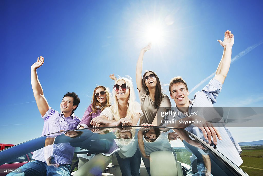 Convertible Car Ride Group Of Young People Enjoying In A Convertible Car Ride High-Res Stock ...