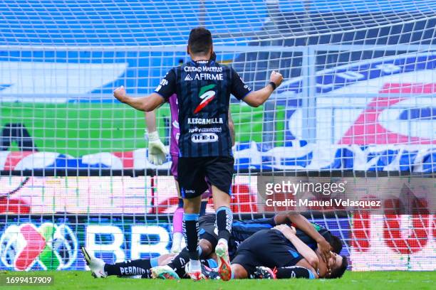Nicolás Cordero of Querétaro celebrates with teammates after scoring the team's third goal during the 9th round match between Cruz Azul and Queretaro...