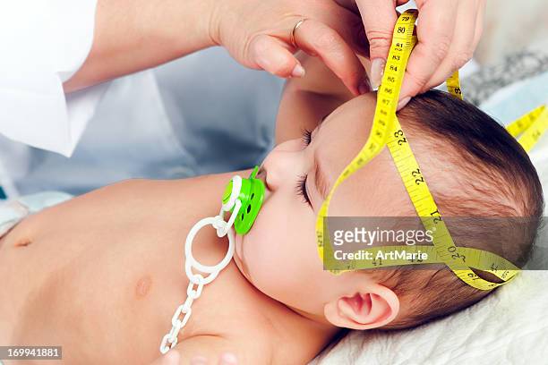 pediatrician measuring baby's head - baby m stock pictures, royalty-free photos & images
