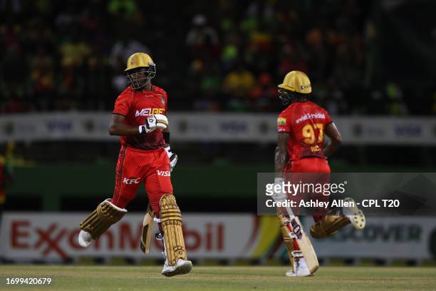 Dwayne Bravo and Keacy Carty of Trinbago Knight Riders run between the wickets during the Republic Bank Caribbean Premier League Final between...