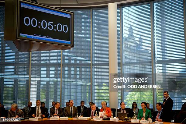 German defence minister Thomas de Maiziere confers with committee chairperson Susanne Kastner before being questioned during a German parliament...