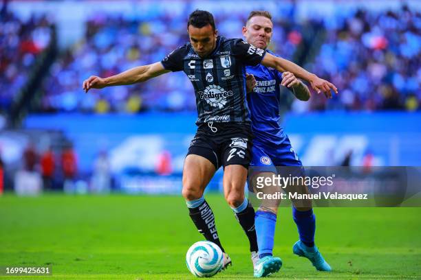 Omar Mendoza of Querétaro struggles for the ball against Carlos Rotondi of Cruz Azul during the 9th round match between Cruz Azul and Queretaro as...