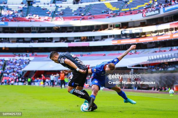 Pablo Barrera of Querétaro struggles for the ball against Carlos Rotondi of Cruz Azul during the 9th round match between Cruz Azul and Queretaro as...
