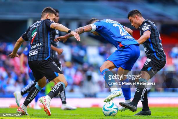 Juan Escobar of Cruz Azul struggles for the ball against Kevin Escamilla and Pablo Barrera of Querétaro during the 9th round match between Cruz Azul...