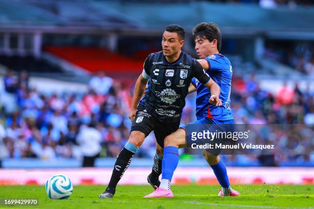 Pablo Barrera of Querétaro struggles for the ball against Alexis Gutiérrez of Cruz Azul during the 9th round match between Cruz Azul and Queretaro as...