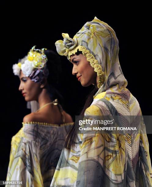 Models present creations by Indian designers Dhruv and Pallavi during the Wills India Fashion Week Spring Summer 2010 in New Delhi on October 28,...