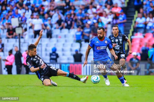 Kevin Escamilla of Querétaro struggles for the ball against Moisés Vieira of Cruz Azul during the 9th round match between Cruz Azul and Queretaro as...