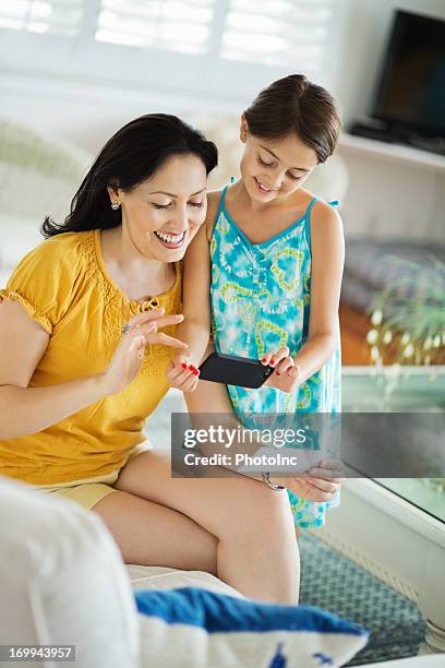 daughter and mother using smart phone to deposit check - cheque deposit stock pictures, royalty-free photos & images