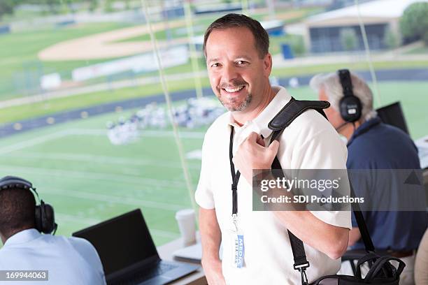 media member arriving in press box at football game - sports commentator stock pictures, royalty-free photos & images