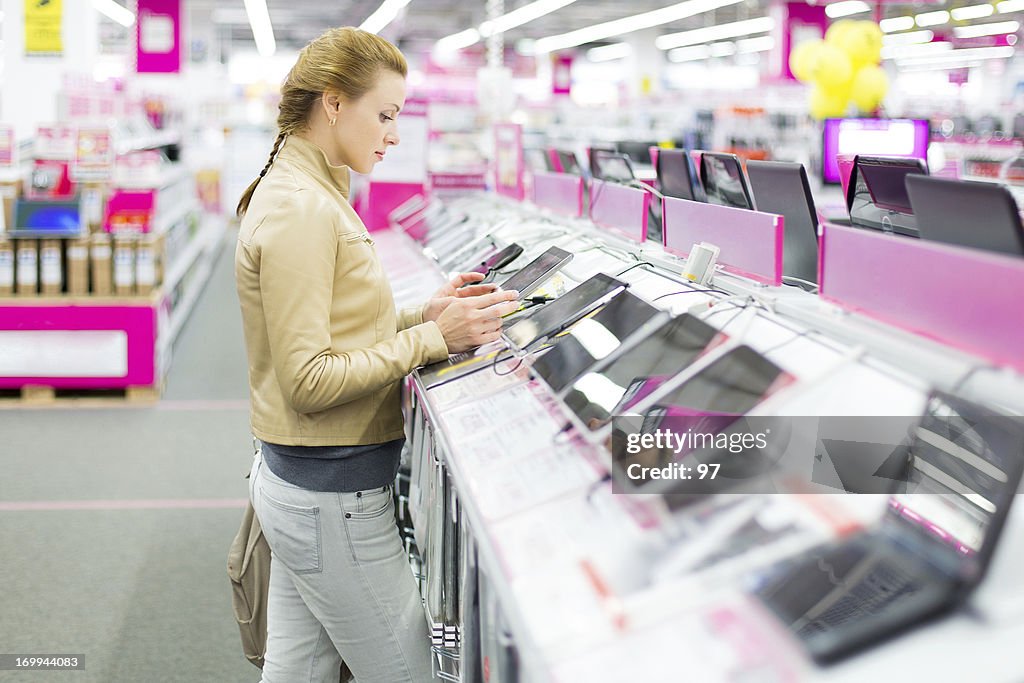 Woman buys a digital tablet at store