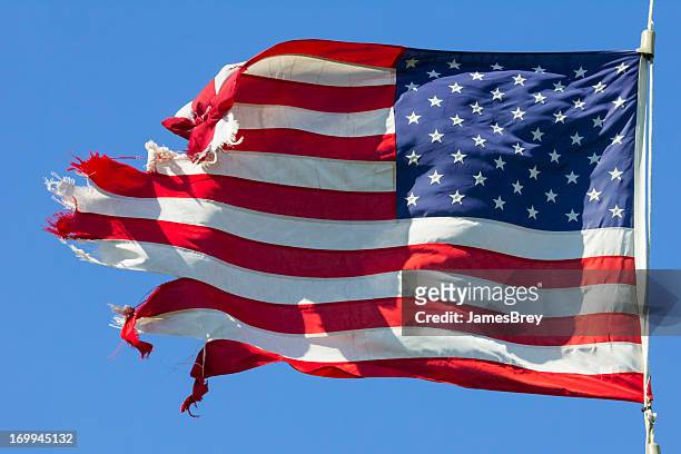 tattered american flag, still flying free and proud - run down stock pictures, royalty-free photos & images