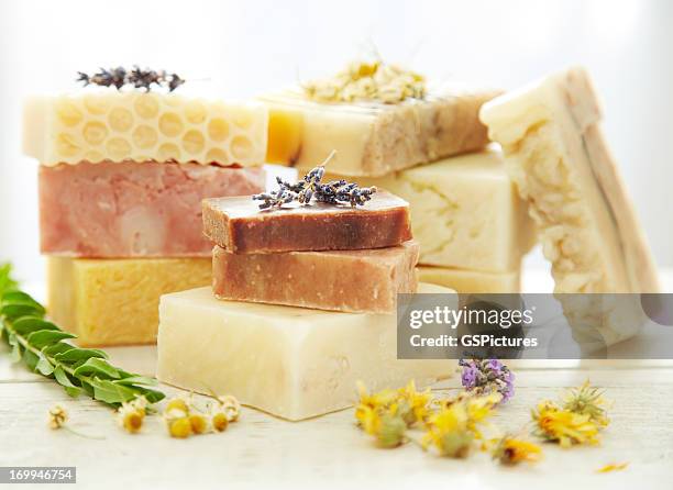 stacks homemade organic bars of soap with lavender on top - soap bar stock pictures, royalty-free photos & images