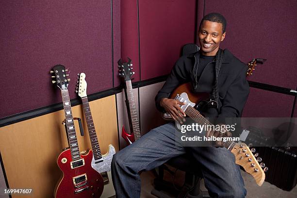 smiling guitarist in the recording studio - rocking chair stock pictures, royalty-free photos & images