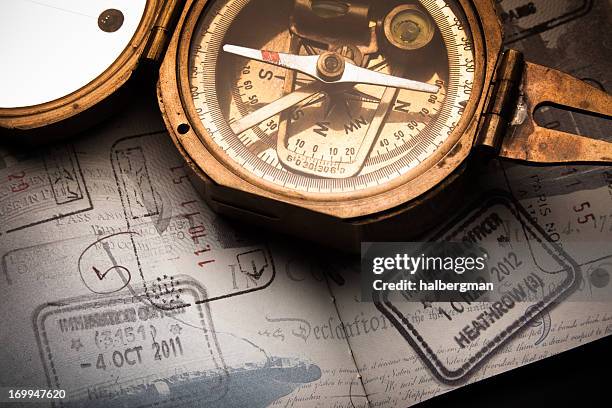 antique compass and well-traveled passport - western europe stock pictures, royalty-free photos & images