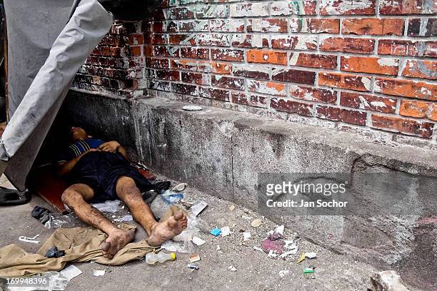 Colombian drug addict lies on the street in the slum of Calvario on 5 April 2004 in Cali, Colombia. Calvario, a slum right in the centre of the city,...