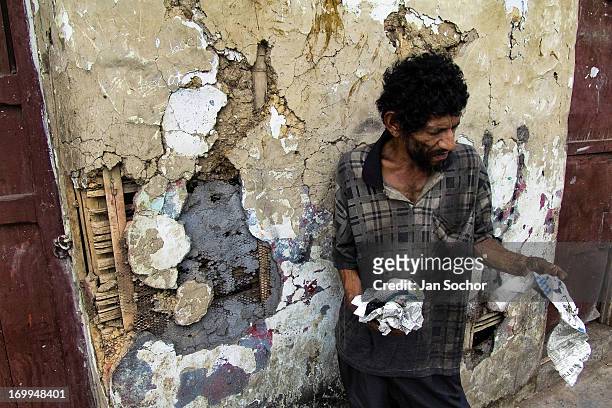 Colombian homeless man stands on the street in the slum of Calvario on 5 April 2004 in Cali, Colombia. Calvario, a slum right in the centre of the...