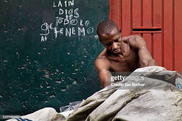 Colombian garbage recollector checks his cart on the street in the slum of Calvario on 20 April 2004 in Cali, Colombia. Calvario, a slum right in the...