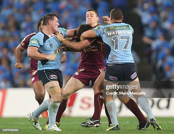 Paul Gallen of the Blues punches Nate Myles of the Maroons during game one of the ARL State of Origin series between the New South Wales Blues and...