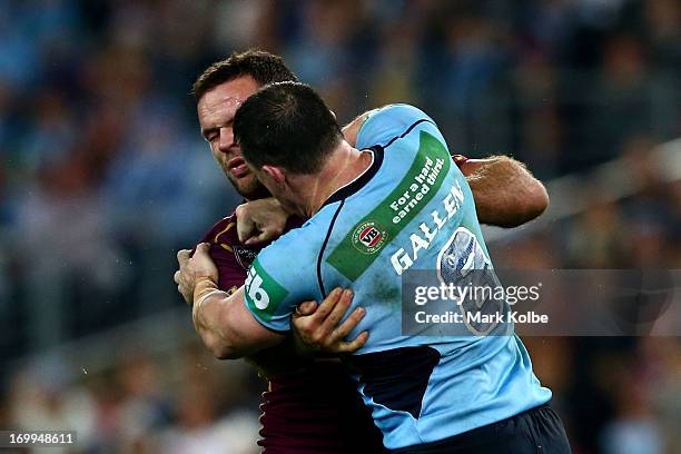 Paul Gallen of the Blues punches Nate Myles of the Maroons during game one of the ARL State of Origin series between the New South Wales Blues and...