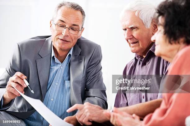 senior couple meeting with financial advisor - lawyer explaining stock pictures, royalty-free photos & images