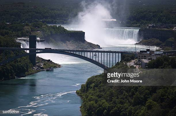 The Rainbow Bridge crosses from the United States , into Canada near the Niagara Falls on June 4, 2013 at Niagara Falls, New York. The falls, which...