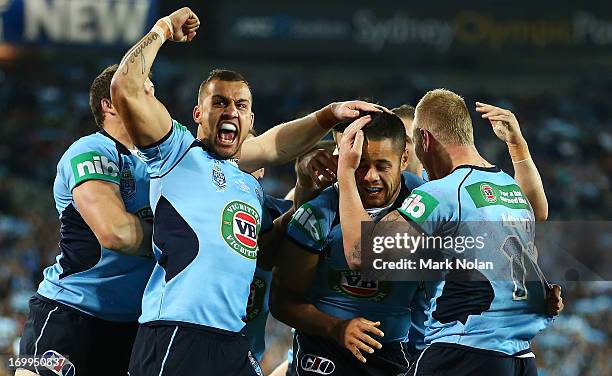 Blake Ferguson, Jarryd Hayne and Luke Lewis of the Blues celebrate a try by Jarryd Hayne during game one of the ARL State of Origin series between...