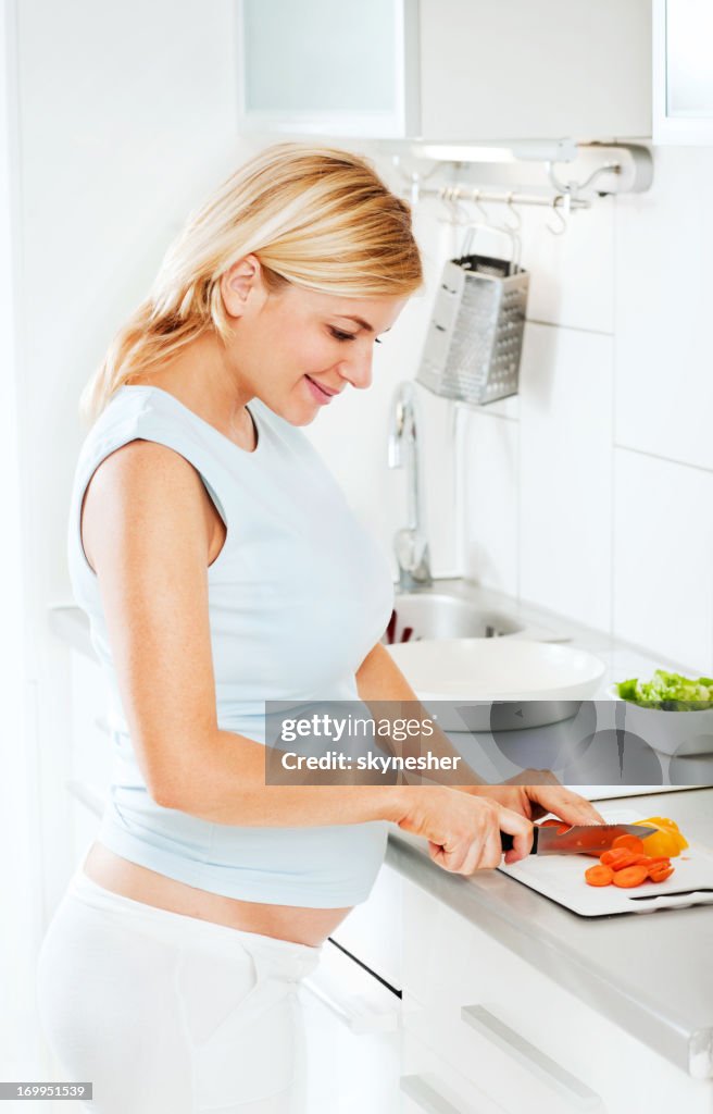 Pregnant woman makes lunch