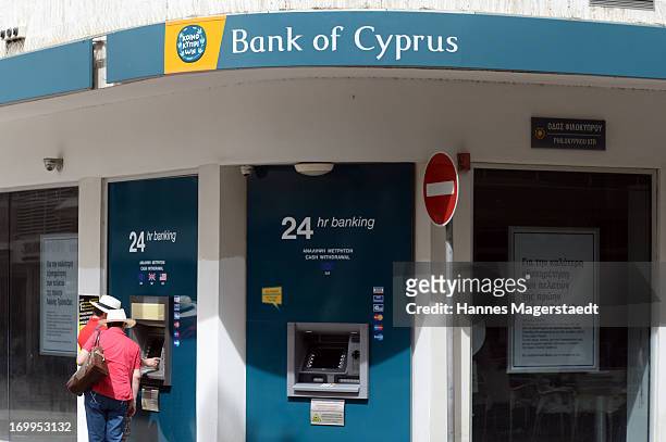 Tourists withdraw at a cashpoint of the Bank of Cyprus in Nicosia on May 25, 2013 in Nicosia, Cyprus. Cyprus is continuing to struggle with the...