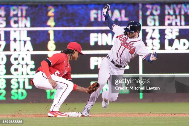 Forrest Wall of the Atlanta Braves beats the tag by CJ Abrams of the Washington Nationals to steal second base in the third inning during game two of...