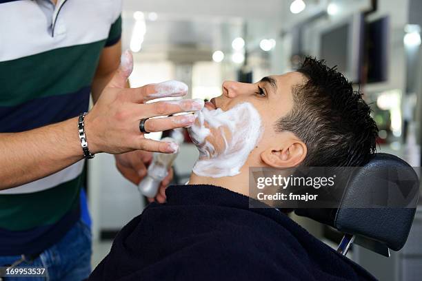 having a shave at the barbers - shave barber stock pictures, royalty-free photos & images
