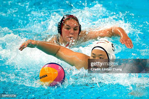 He Jin of China challenges Kelly Rulon of the United States during day fifth of the FINA Women's World League Super Final 2013 match between United...