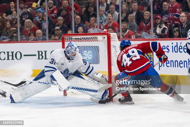 Rafael Harvey-Pinard of the Montreal Canadiens pushes the puck against Martin Jones of the Toronto Maple Leafs during the second period of the NHL...