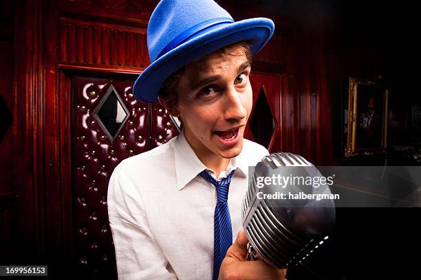 lounge singer with microphone - man singing stockfoto's en -beelden