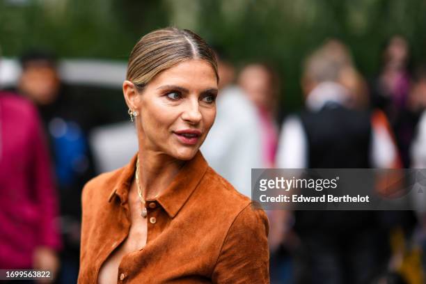 Martina Colombari wears earrings, an orange suede jacket, outside Tod's, during the Milan Fashion Week - Womenswear Spring/Summer 2024 on September...
