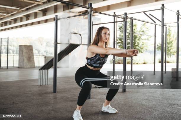 young woman exercising with rubber band - gummiband stock-fotos und bilder