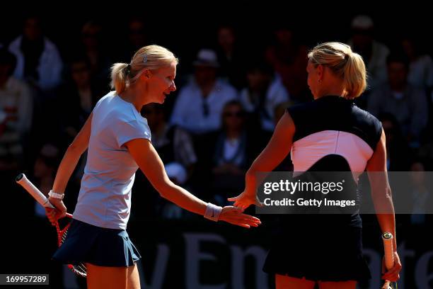 Jana Novotna of Czech Repulic taps hands with Barbara Schett of Austria talk tactics during their women's legends match against Lindsay Davenport of...