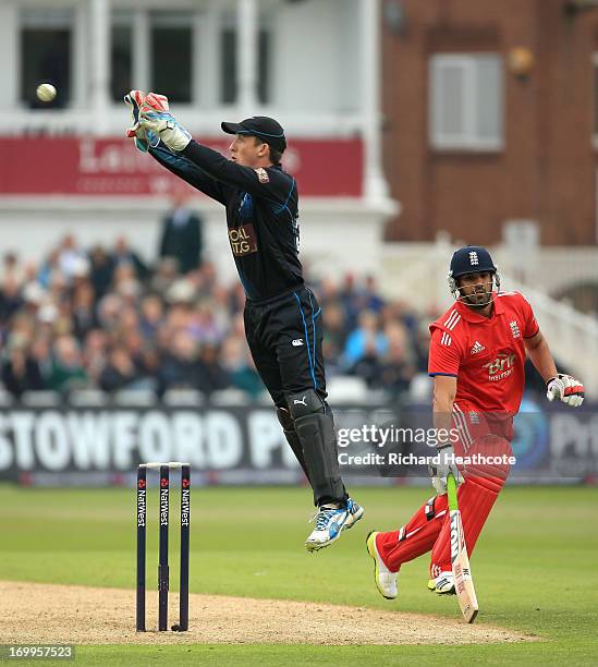 Luke Ronchi of New Zealnd gathers a throw as Ravi Bopara of England tries to make his crease during the 3rd Natwest Series ODI match between England...