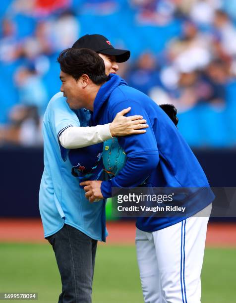Oh Se-hoon, Mayor of Seoul, South Korea hugs Hyun Jin Ryu of the Toronto Blue Jays after throwing out the first pitch, prior to a game against the...