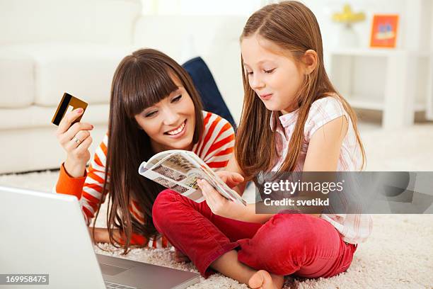 mother and daughter buying on internet. - catalogue stock pictures, royalty-free photos & images