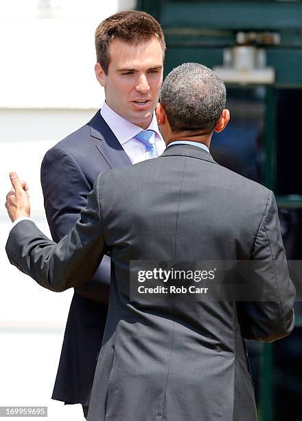 President Barack Obama talks with quarterback Joe Flacco after welcoming members of the National Football League Super Bowl champion Baltimore Ravens...