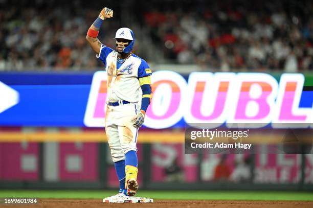 Ronald Acuna Jr. #13 of the Atlanta Braves celebrates after hitting a double against the Washington Nationals during the fifth inning at Truist Park...