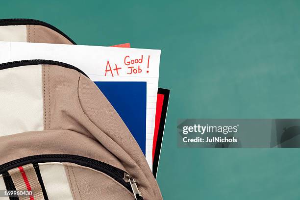 good job: a+ on homework or test paper in backpack - add stock pictures, royalty-free photos & images