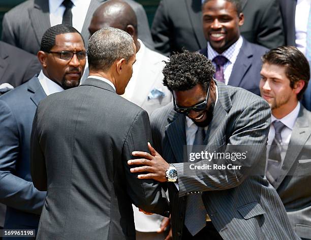 President Barack Obama shakes hands with safety Ed Reed after welcoming members of the National Football League Super Bowl champion Baltimore Ravens...