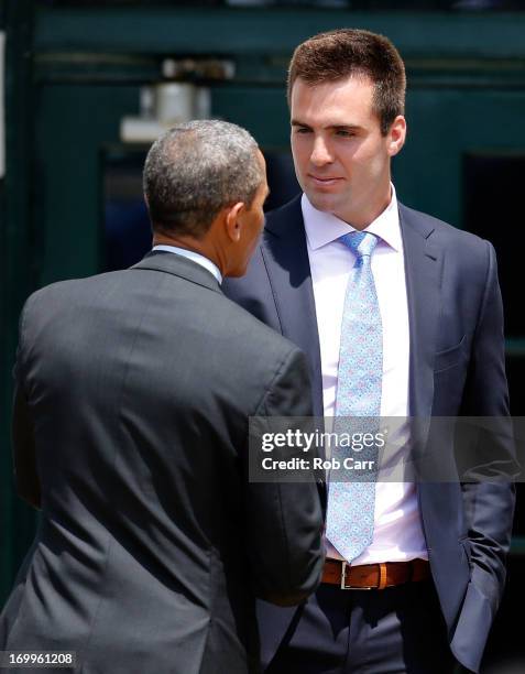 President Barack Obama talks with quarterback Joe Flacco after welcoming members of the National Football League Super Bowl champion Baltimore Ravens...