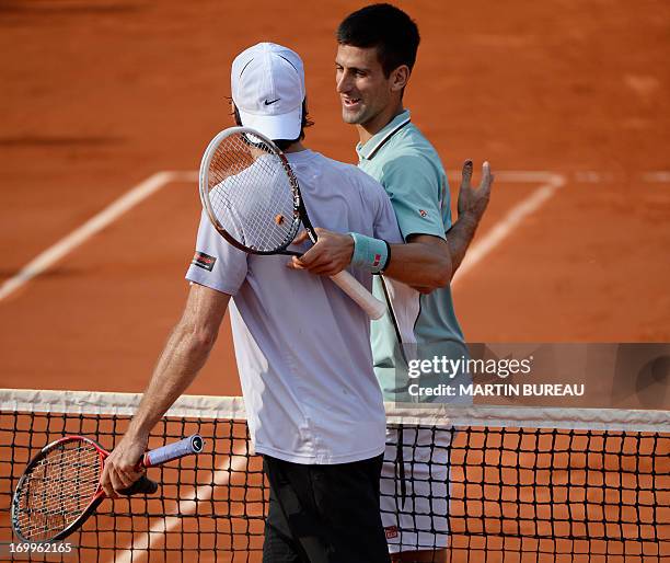 Serbia's Novak Djokovic is congratulated by Germany's Tommy Haas after winning aFrench tennis Open quarter final match t at the Roland Garros stadium...